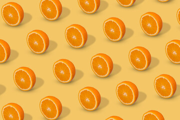 Fresh sliced orange on bright yellow background. Fruit pattern