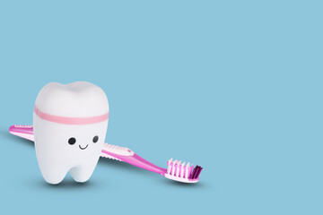 Toothbrush and white tooth on a bright blue background.