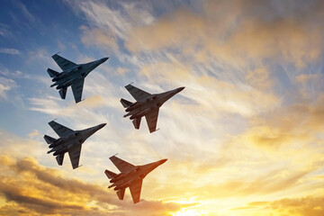 Four fighter jets in the shape of a diamond in the sky beautiful sunset. - obrazy, fototapety, plakaty