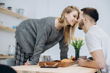 Fototapeta premium Young couple having breakfast in kitchen.