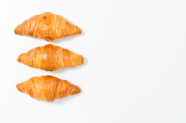 Three fresh croissants isolated on a white background