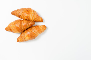 Three fresh croissants isolated on a white background