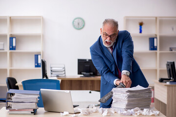 Old male employee unhappy with excessive work in the office