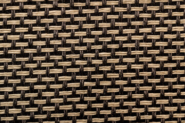 Brown and yellow woven fabric texture closeup.