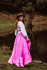 woman in a hat and a pink dress in madeira portugal