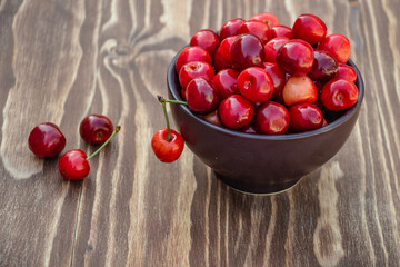 ripe cherries on brown background, delicious appetizing cherries