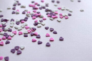 purple confectionery hearts scattered on the background