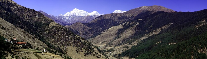 Fototapeta premium Panorama of mountains and snow in the Himalayas trekking along Everest Circuit in Nepal.