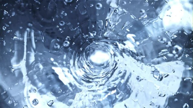 Rotation of water by a whirlpool with air bubbles. Macro background. The texture of the water. Filmed is slow motion 1000 fps.