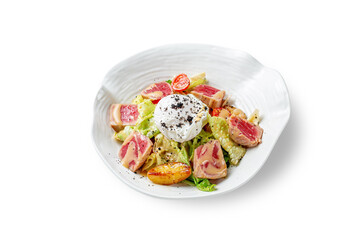 A warm salad of roasted tuna, red onions, fresh cherry tomatoes with a sauce of juicy oranges in a plate on a white isolated background.