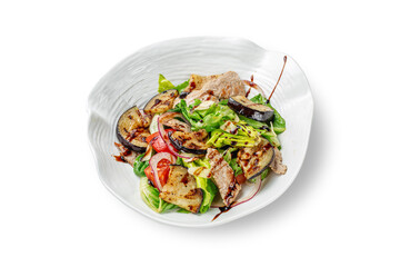 Baked eggplant salad with pork tenderloin, onions, mixed lettuce and aromatic fresh basil dressing in a plate with high edges on a white isolated background
