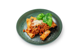 Italian pasta Conchiglioni Rigati stuffed with dry tomatoes and meat with basil and cheese in a plate on a white insulated background