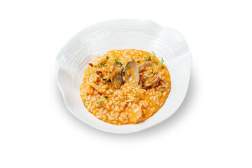 Italian dish seafood risotto, shrimps and squids in a creamy sauce with lemon in a plate on a white isolated background.  Top view, copy space.