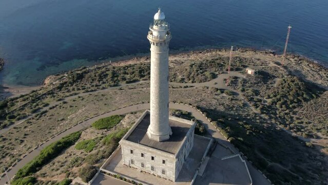 Aerial shot, drone point of view Cabo de Palos lighthouse of La Manga del Mar Menor in seaside spit of Mar Menor in the Region of Mursia, Spain