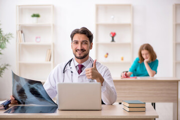 Young male doctor radiologist and female assistant working in th