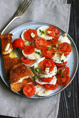 Healthy salad with mozzarella and cherry tomatoes on a plate. Diet food. Proper nutrition. Italian food.