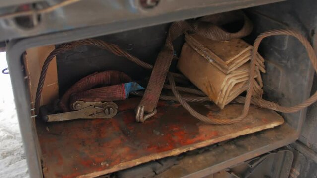 Old car towing cable in trailer trunk
