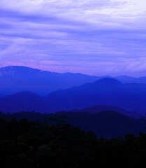 Background image of silhouette mountain range during dusk in Fraser Hill, Pahang, Malaysia.