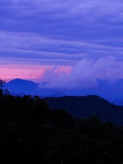 Background image of silhouette mountain range during dusk in Fraser Hill, Pahang, Malaysia.