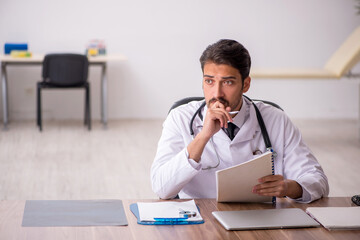 Young male doctor working in the clinic