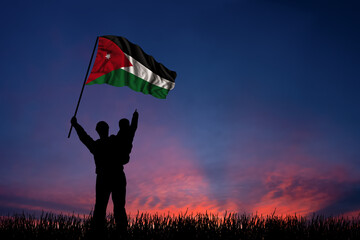 Father and son hold the flag of Jordan - 484044582