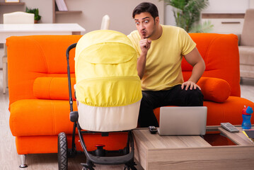 Young man looking after new born at home