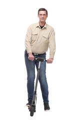 Fototapeta premium A caucasian businessman riding a scooter to work, can be used for green or gas savings concept