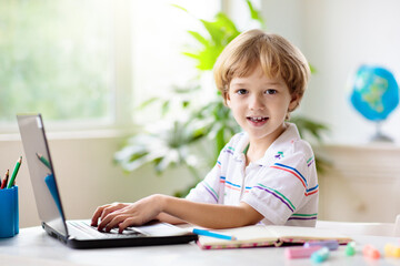 Online remote learning. School kids with computer.