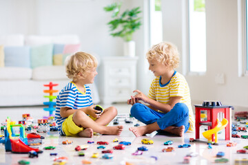 Kids play with toy cars. Children playing car toys