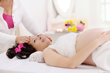 Obraz na płótnie Canvas Pregnancy spa. Massage for pregnant woman.