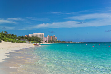 Stunning view of white sandy beach with turquoise water of Atlantic Ocean in Bahamas islands.