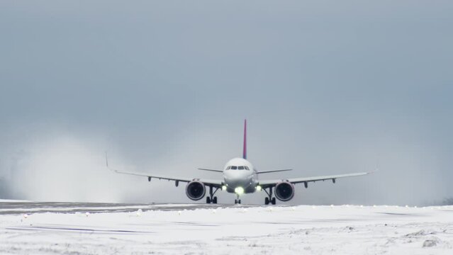 Passenger plane takes off from the runway in the winter in a slow motion 4K video