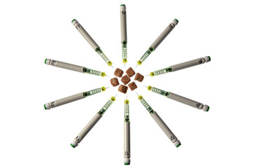 Slices of brown cable sugar surrounded by syringes of pens with insulin