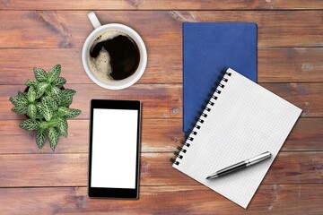 Office calendar, smartphone, cup of coffee and notebook on wooden background