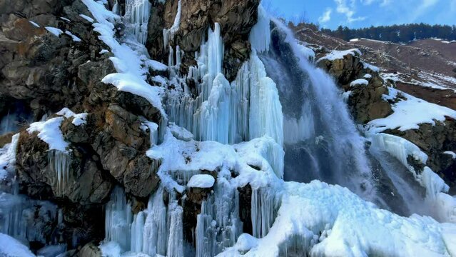 Massive icicle of frozen Great Large Waterfall in The Rocky Mountain in Kashmir winters.