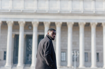young afro man in france walking outside in winter