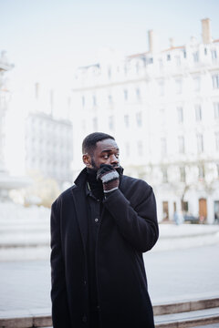 young afro man in france walking outside in winter