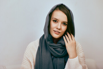 Portrait of white attractive woman in headscarf indoors.