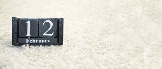 Wooden calendar from blocks on white background with copy space.12th of February