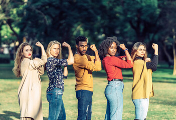 multiethnic people imitating the gesture of rosie the riveter