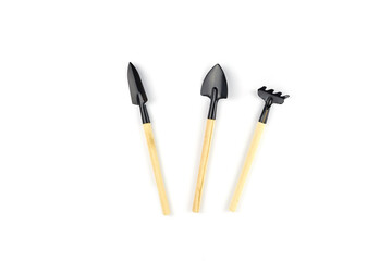Gardening at home. Tools rake and shovels for seedlings. Growing vegetables and herbs at home. Flat lay on white background with space for text