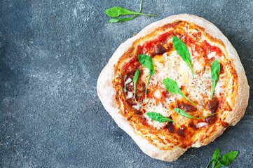 Freshly baked Italian pizza on a gray background. Top view.