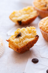 Halved of homemade easy muffins with chocolate chips on a baking paper.