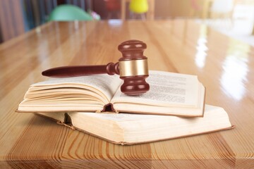 Wooden Judge's gavel on a book on a wooden table. Christian background