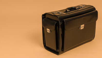 black suitcase on yellow background with copy space
