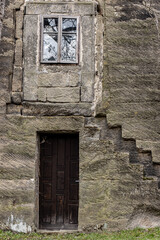 A entrance in stone wall of the historical haunted building known as the House of Alchemist, according to folk chronicles a sorcerer lived here.