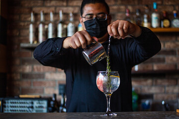 Bartender preparing a cocktail at the bar