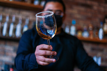 Bartender preparing a drink on a glass