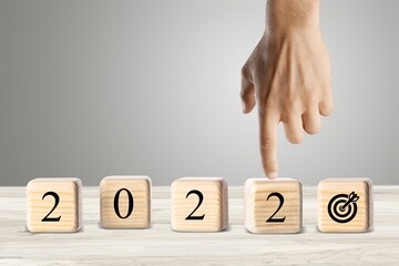 The calendar year 2021 changed to 2022 with the goal and successful concept. wooden cube blocks