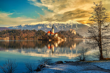 Fototapeta na wymiar Lake Bled, Slovenia. Beautiful mountain lake with small Pilgrimage church at sunset.